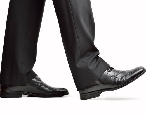 Close up of steps of a businessperson walking with isolated on white background